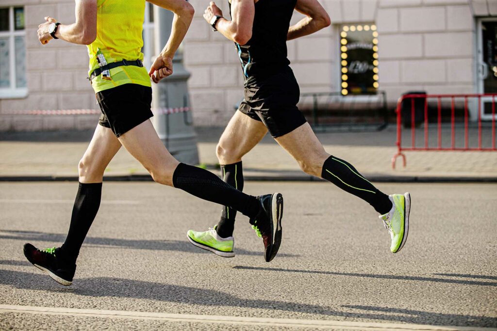 two-men-runners-in-compression-socks-7PJL2YD.jpg